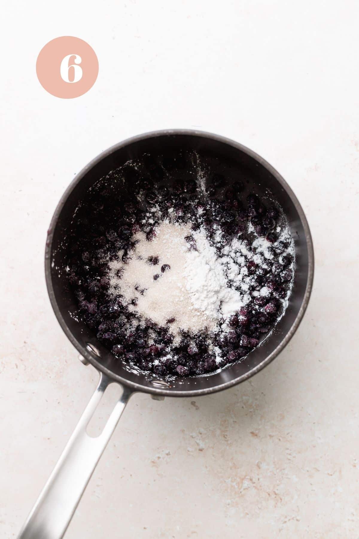 the blueberry compote in a pot for the earl grey cake.