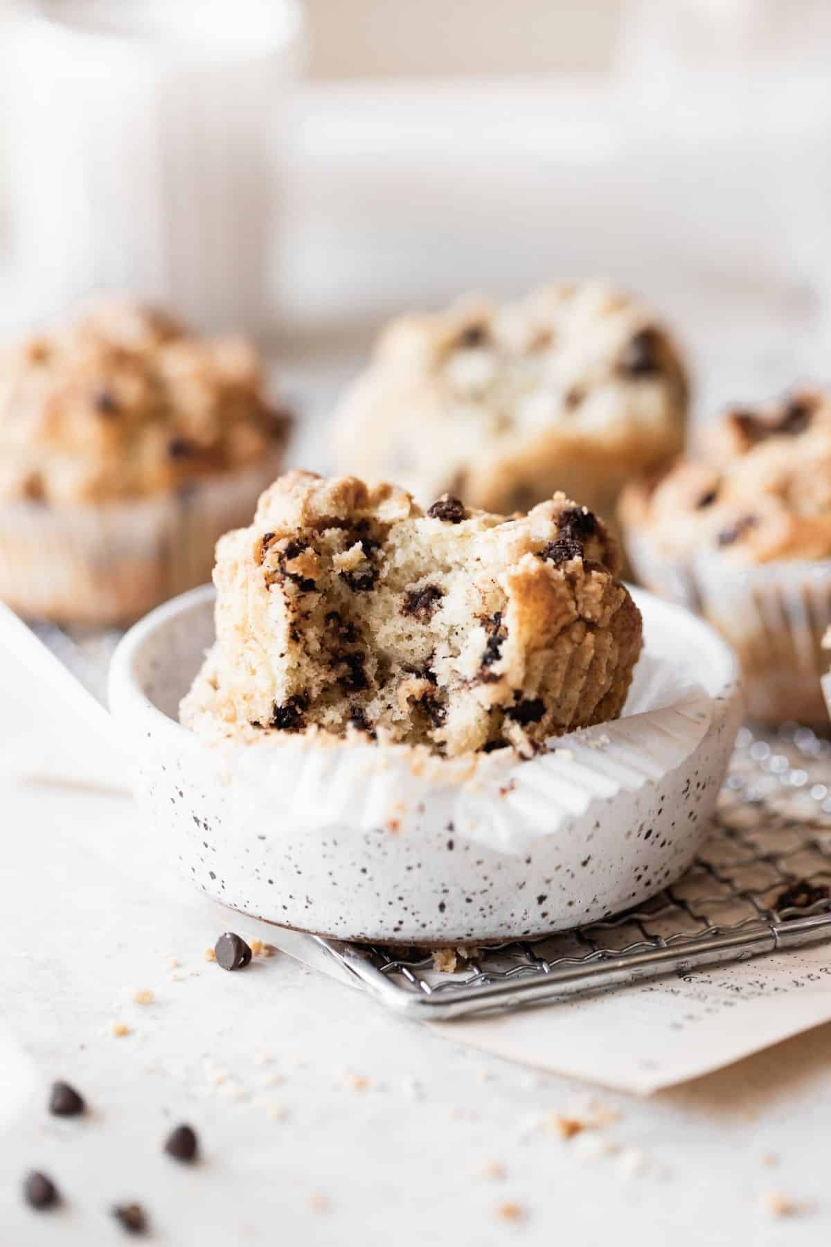 a chocolate chip muffin with a bite taken out of it.
