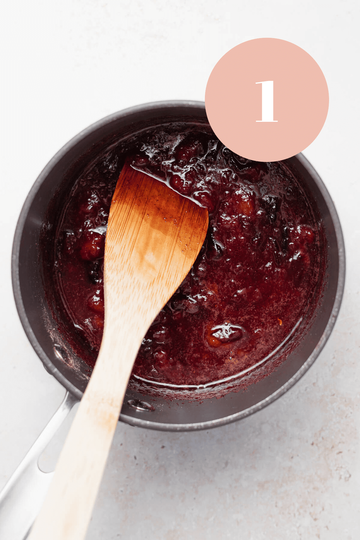 overhead shot of the plum jam cooking in a pot