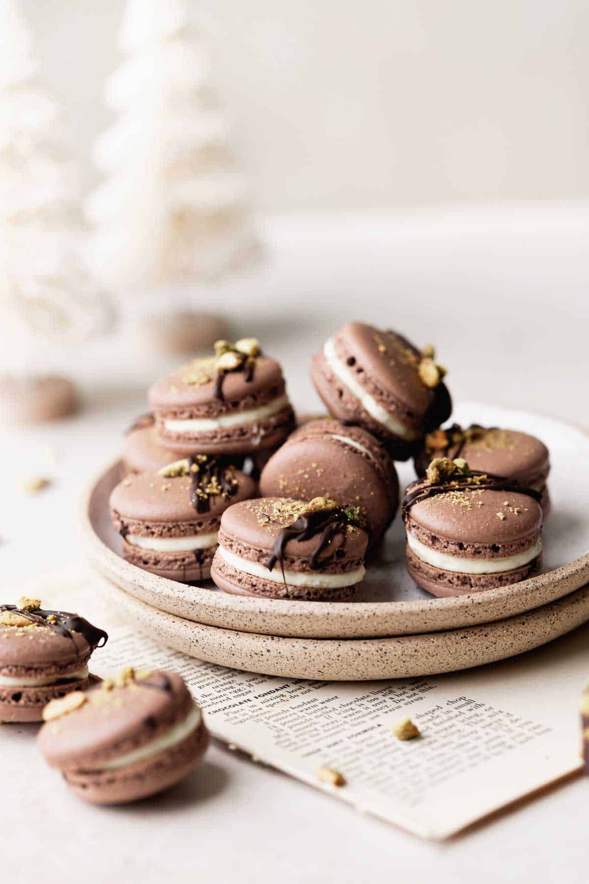 pistachio macarons sitting on a plate.