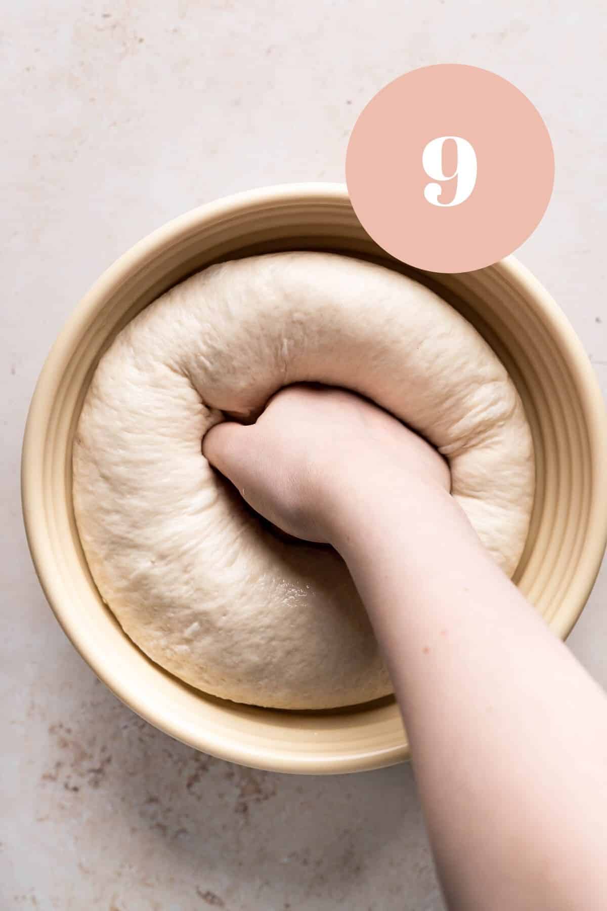 punching down the proofed soft pizza dough.