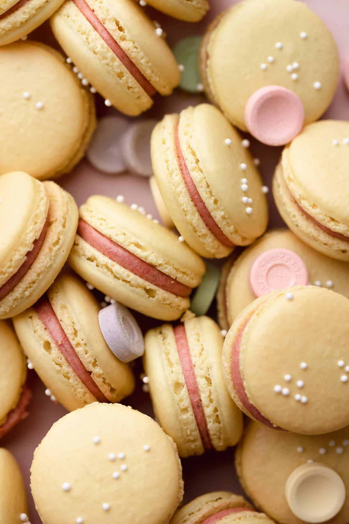 sweet tart macarons in a pile together.