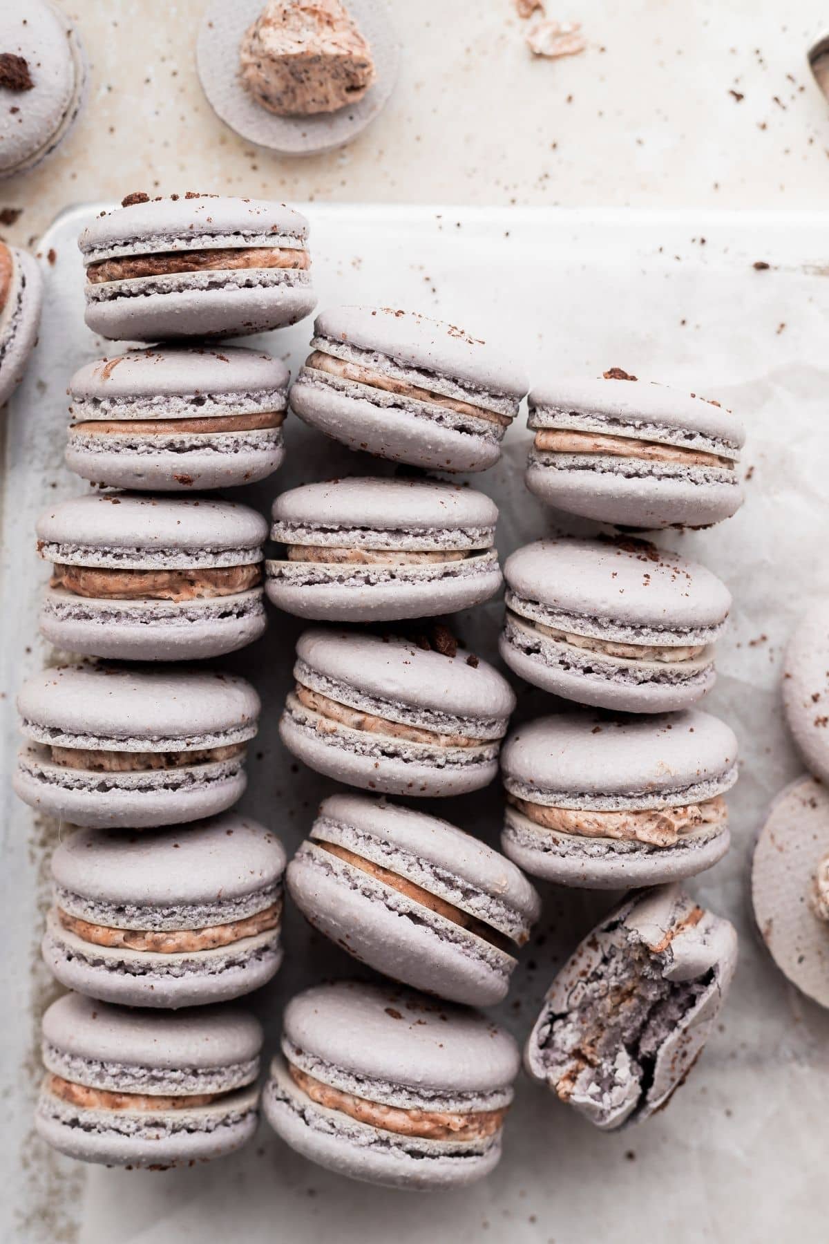 cookies and cream macarons on a white surface.