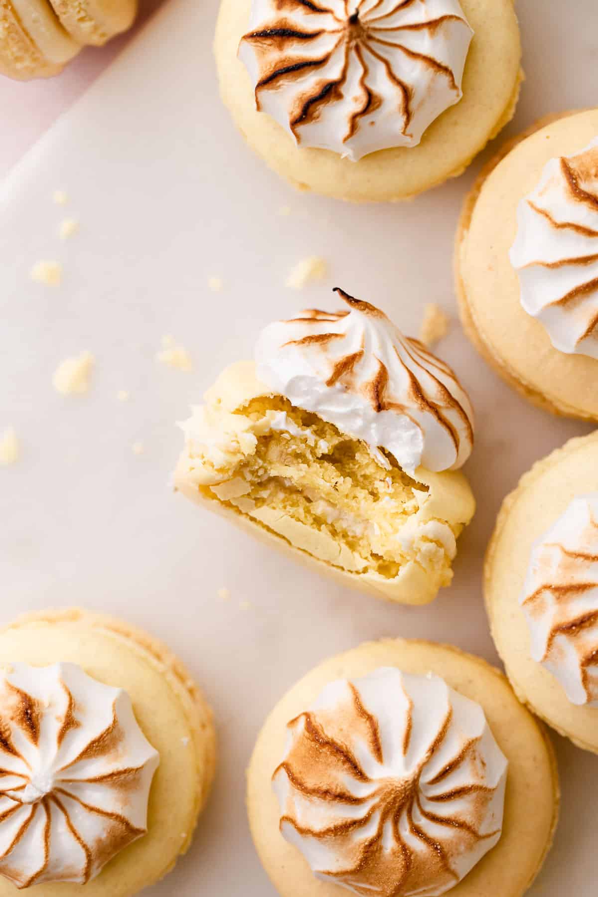 a banana macaron with a bite taken out of it.