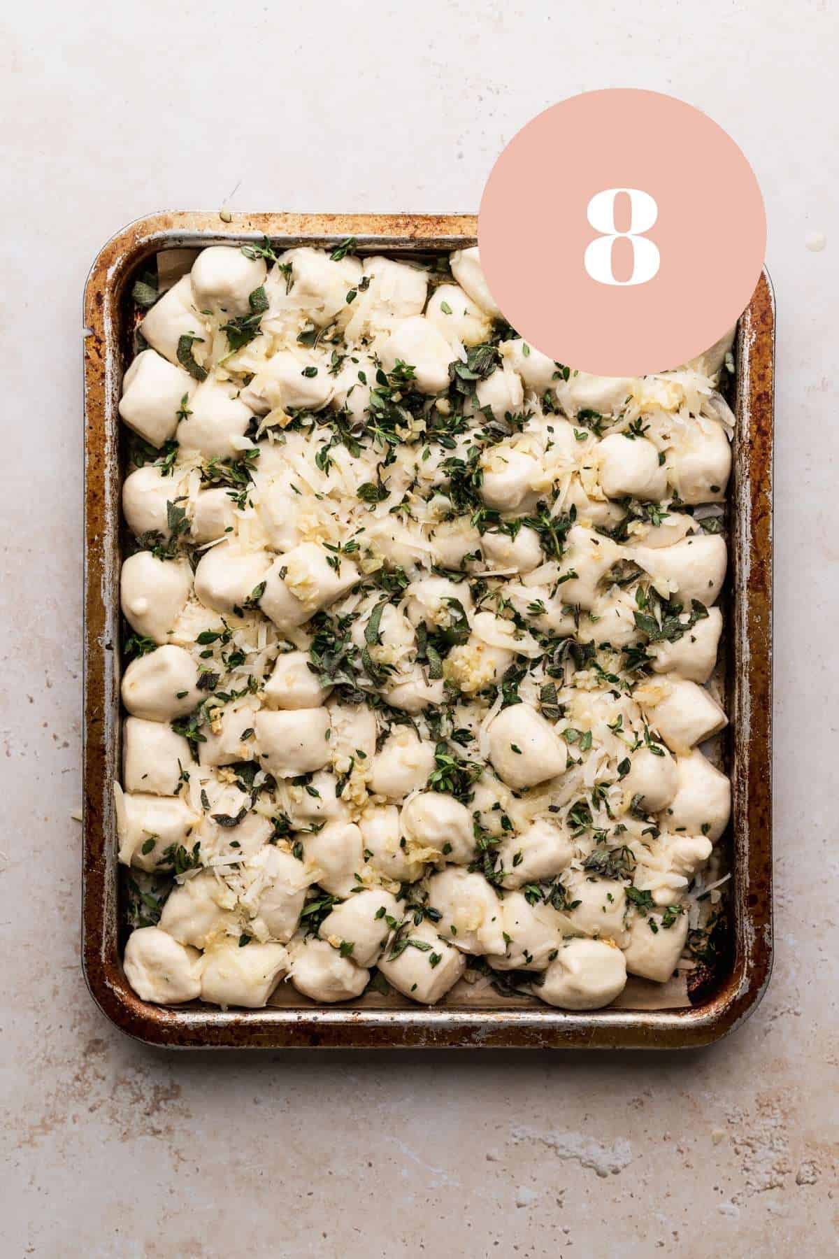 parmesan bread bites topped with garlic butter before baking.