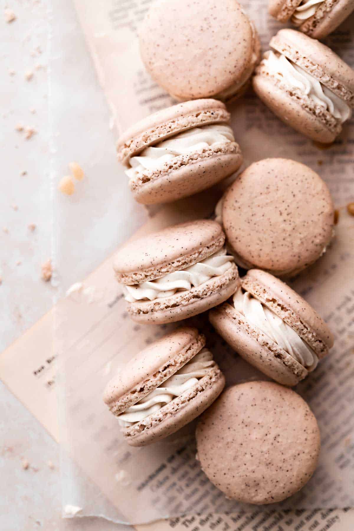 chai macarons on a piece of parchment paper.
