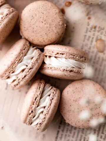 chai macarons on a piece of parchment paper.