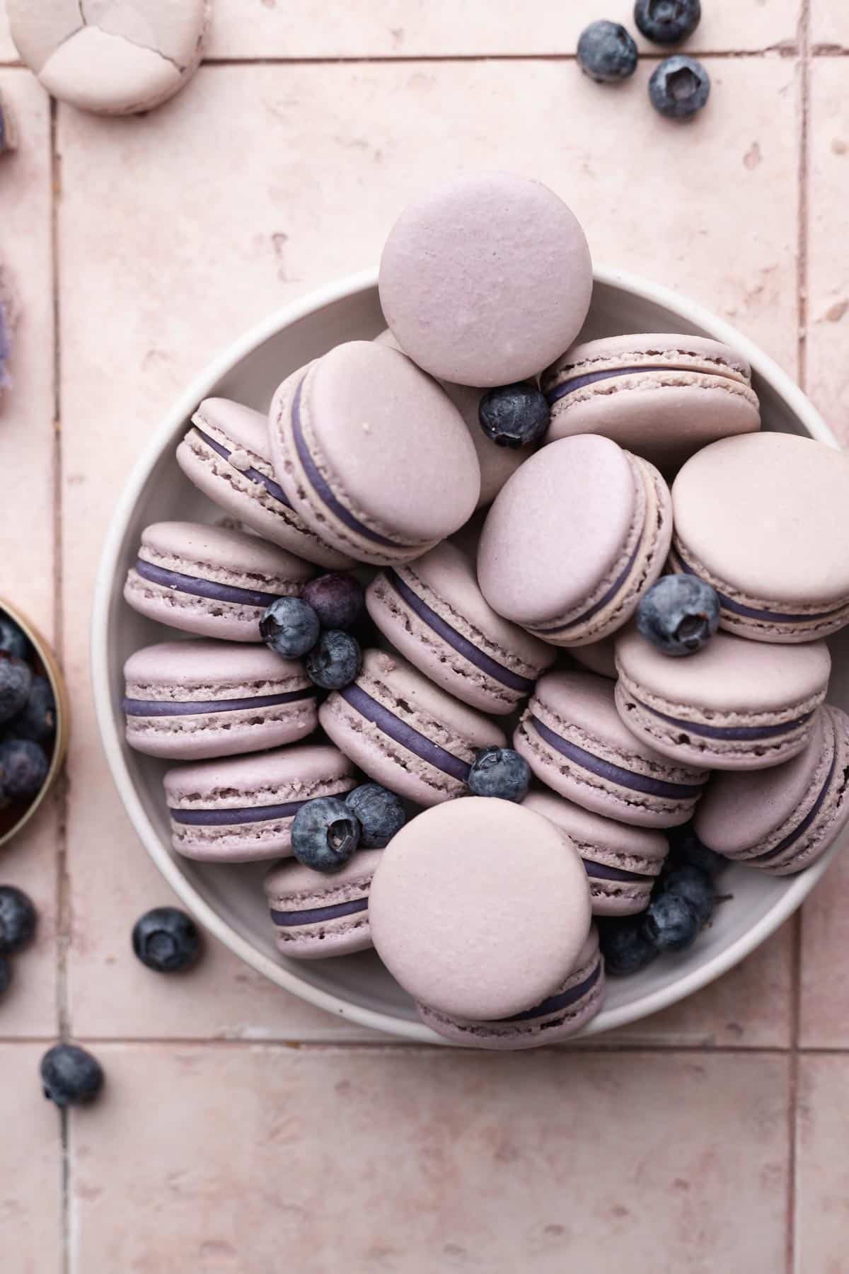 a bowl full of the blueberry macarons.