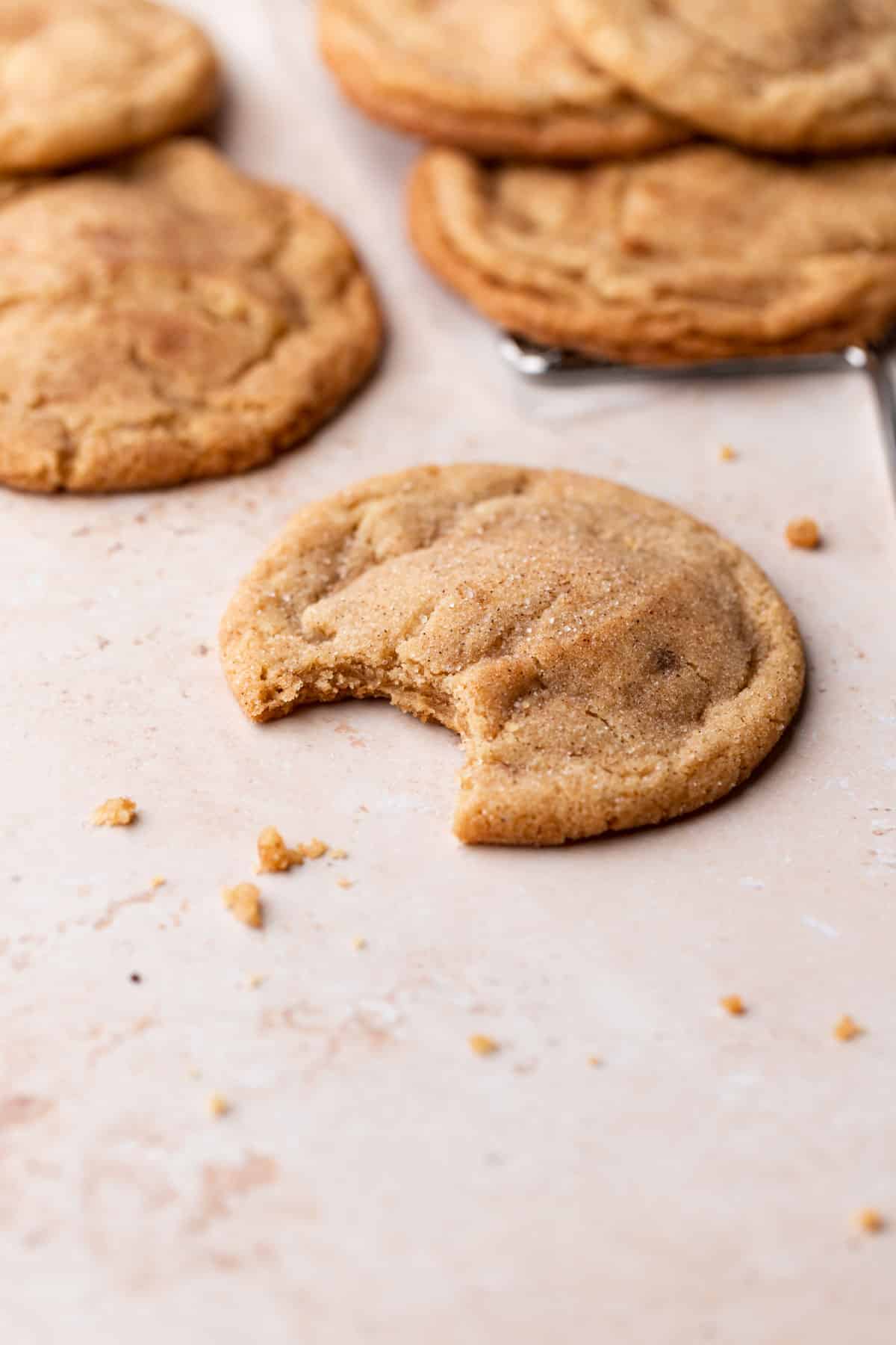 a snickerdoodle cookie with a bite taken out of it.