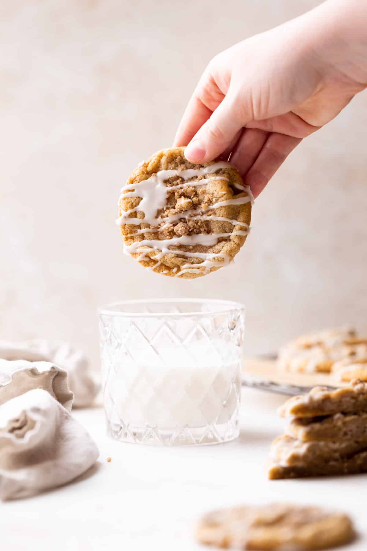 dunking one of the cookies in a glass of milk.