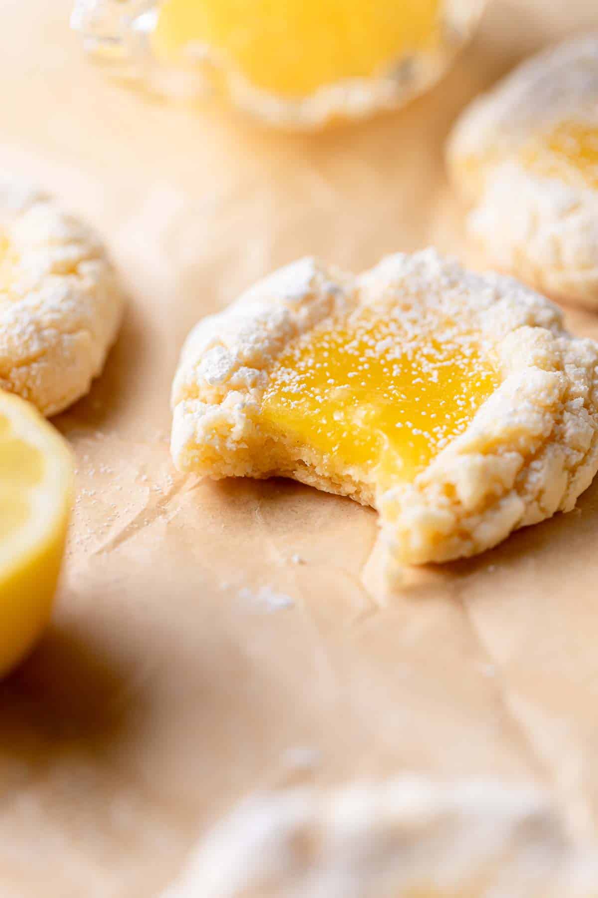 a lemon bar cookie with a bite taken out of it.