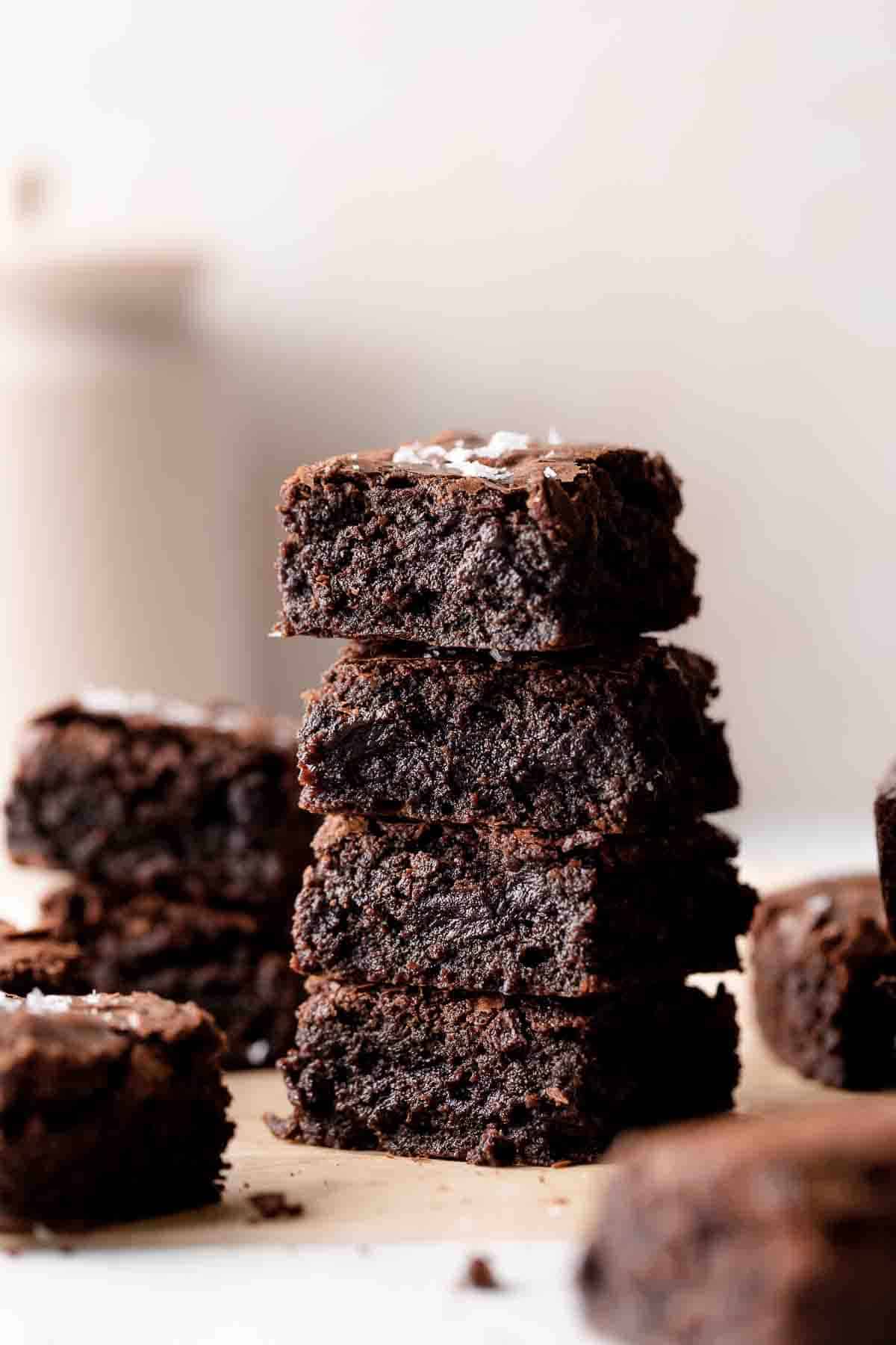 a stack of brownies on parchment paper.