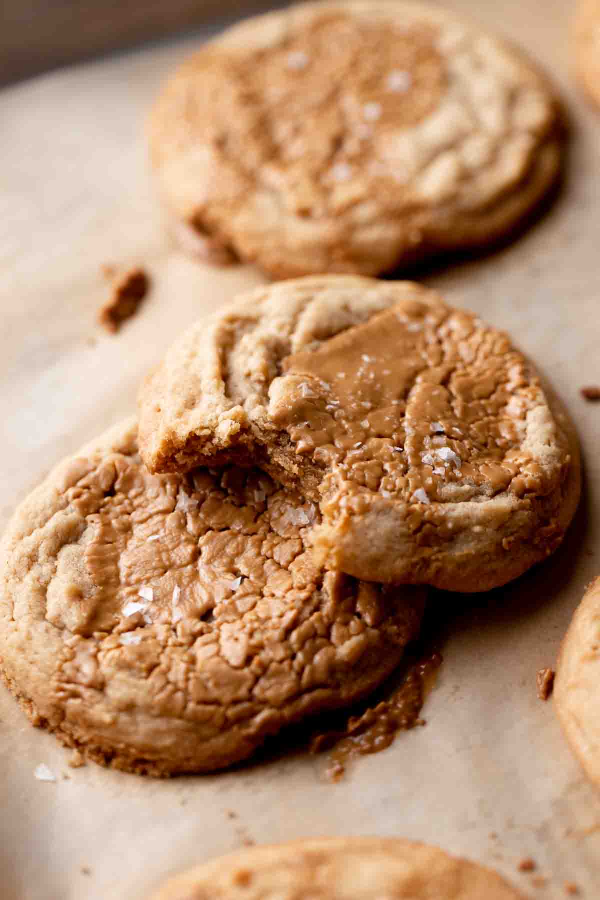 two cookie butter cookies on a parchment lined baking tray.