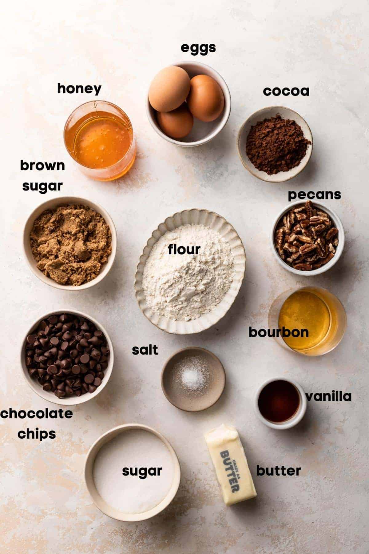 ingredients needed for pecan brownies in bowls with labels.