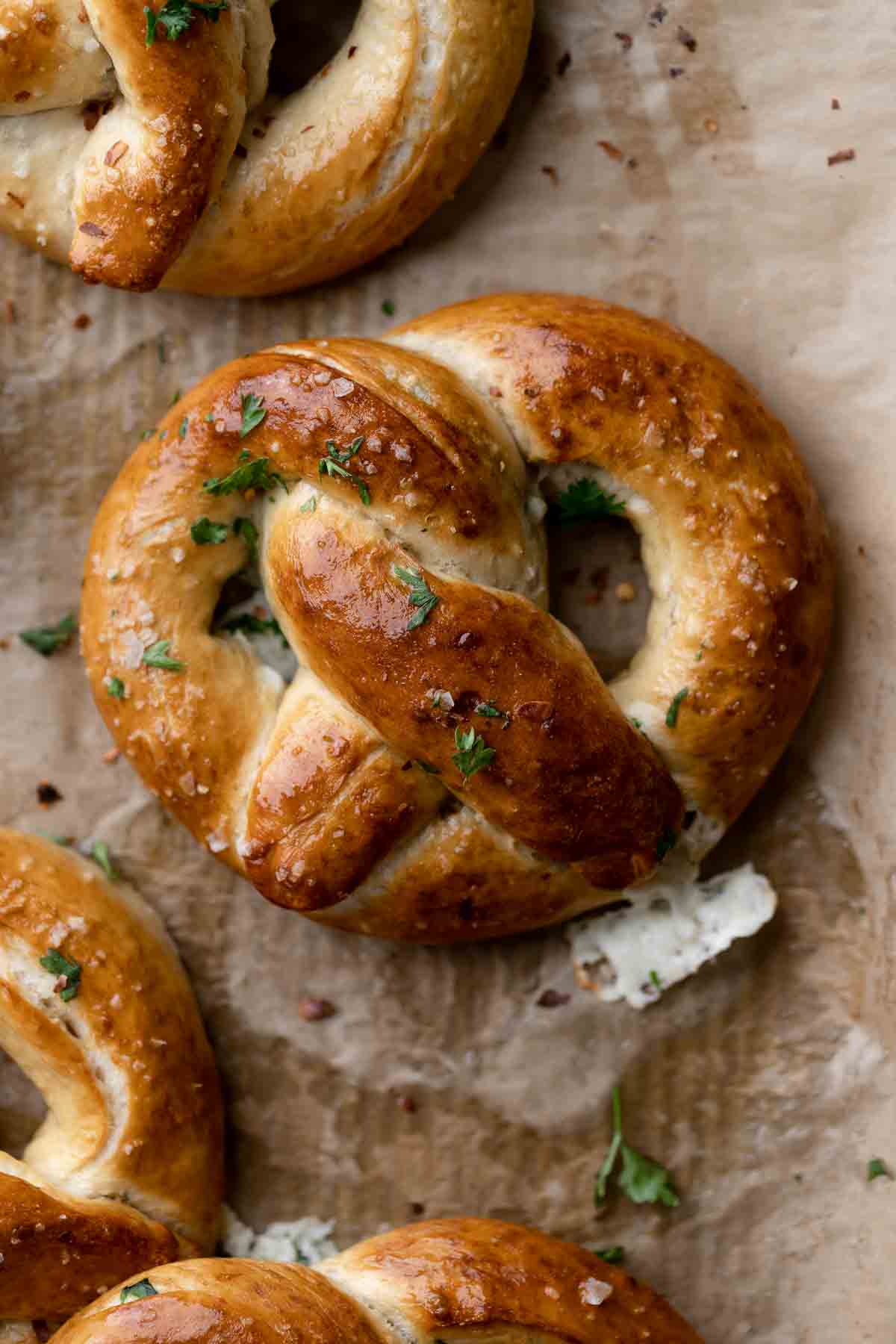 stuffed pretzels on a parchment lined baking tray.
