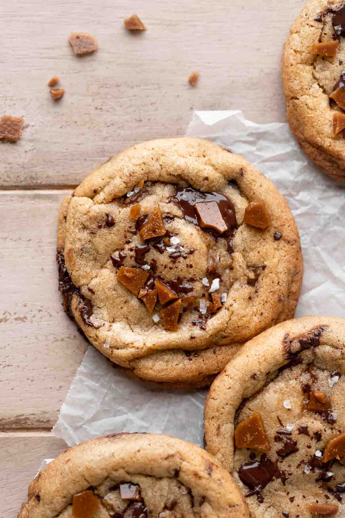 chocolate chip toffee cookie after baking topped with extra toffee pieces.