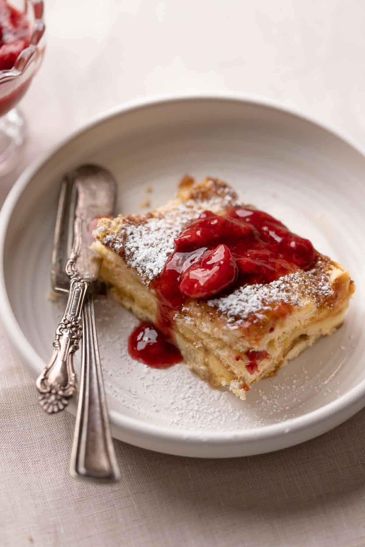 a slice of brioche french toast on a white plate.