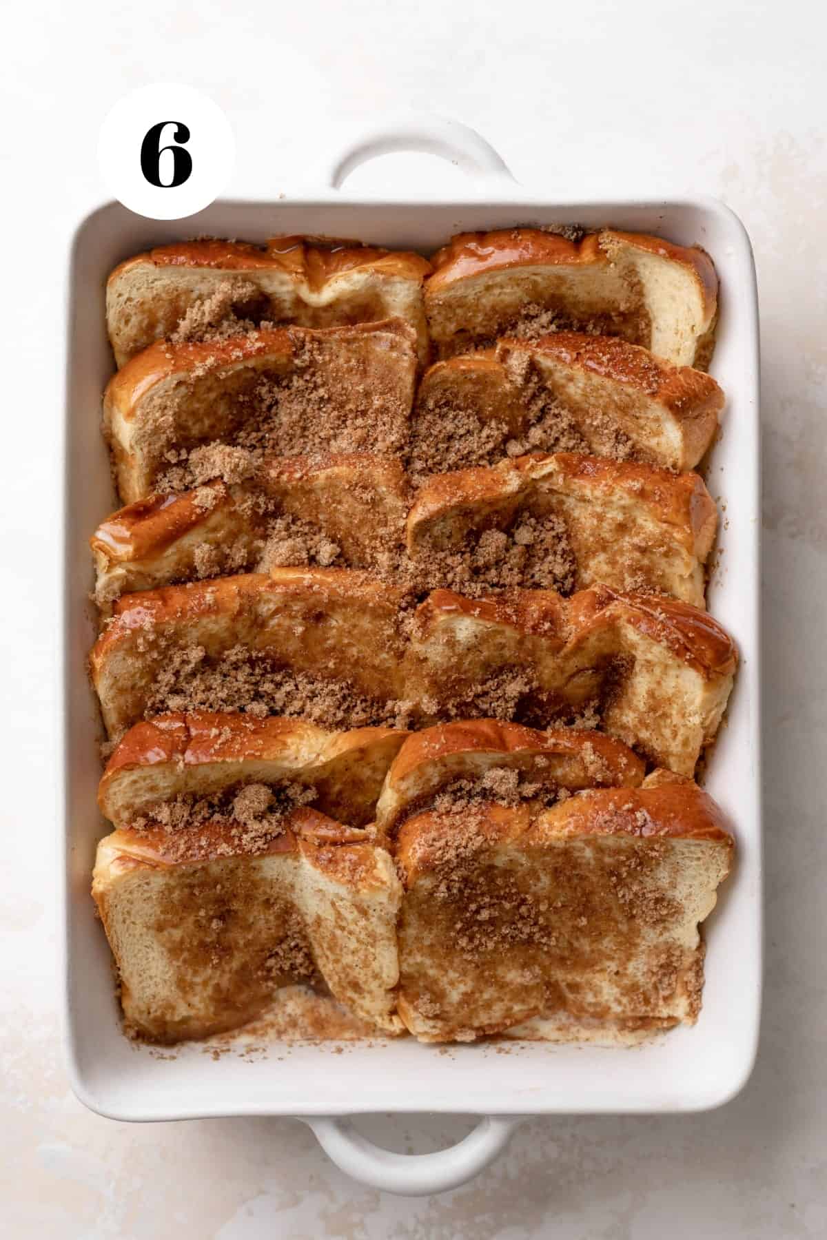 the brioche french toast before baking sprinkled with brown sugar.