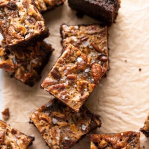 bourbon pecan pie brownies cut into squares on a baking tray.