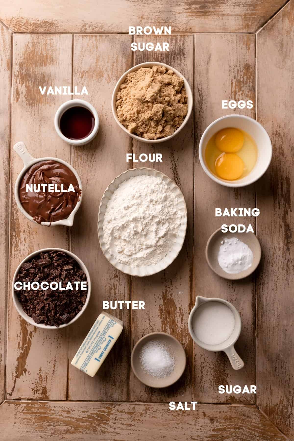 ingredients needed to make chocolate filled cookies in bowls with labels.