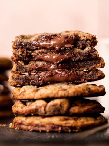 a stack of chocolate filled cookies with nutella oozing out.