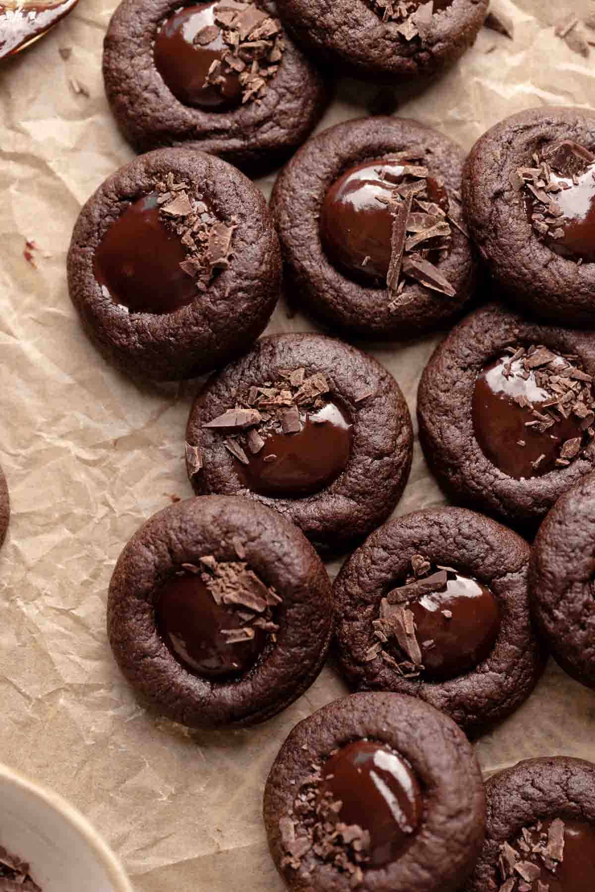 chocolate thumbprint cookies filled with ganache and sprinkled with shaved chocolate.