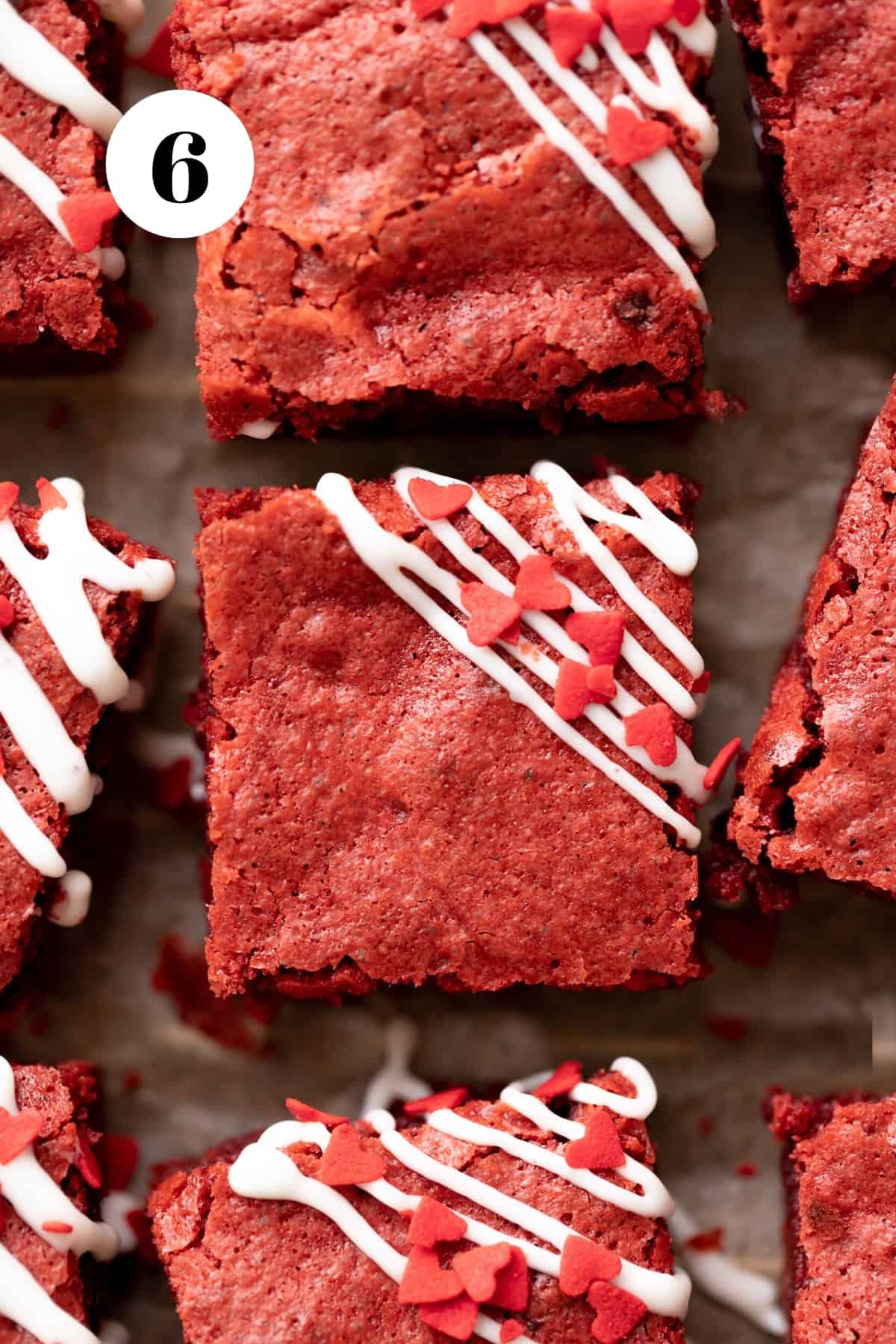 red velvet brownies with cream cheese drizzled on top.