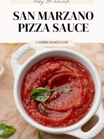 san marzano pizza sauce with fresh basil and salt in a white baking dish.