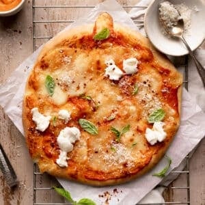 vodka sauce pizza topped with fresh mozzarella, basil, and red pepper flakes.