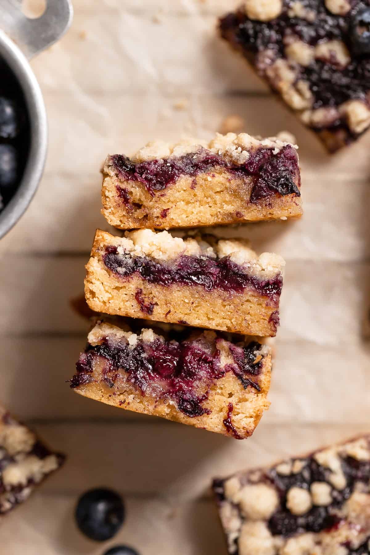 blondies with blueberry jam on parchment paper.