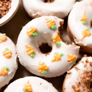 carrot cake donuts topped with cream cheese icing.