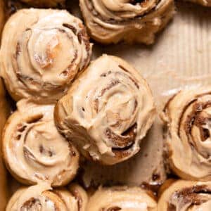 coffee cinnamon rolls with coffee frosting in a baking pan.