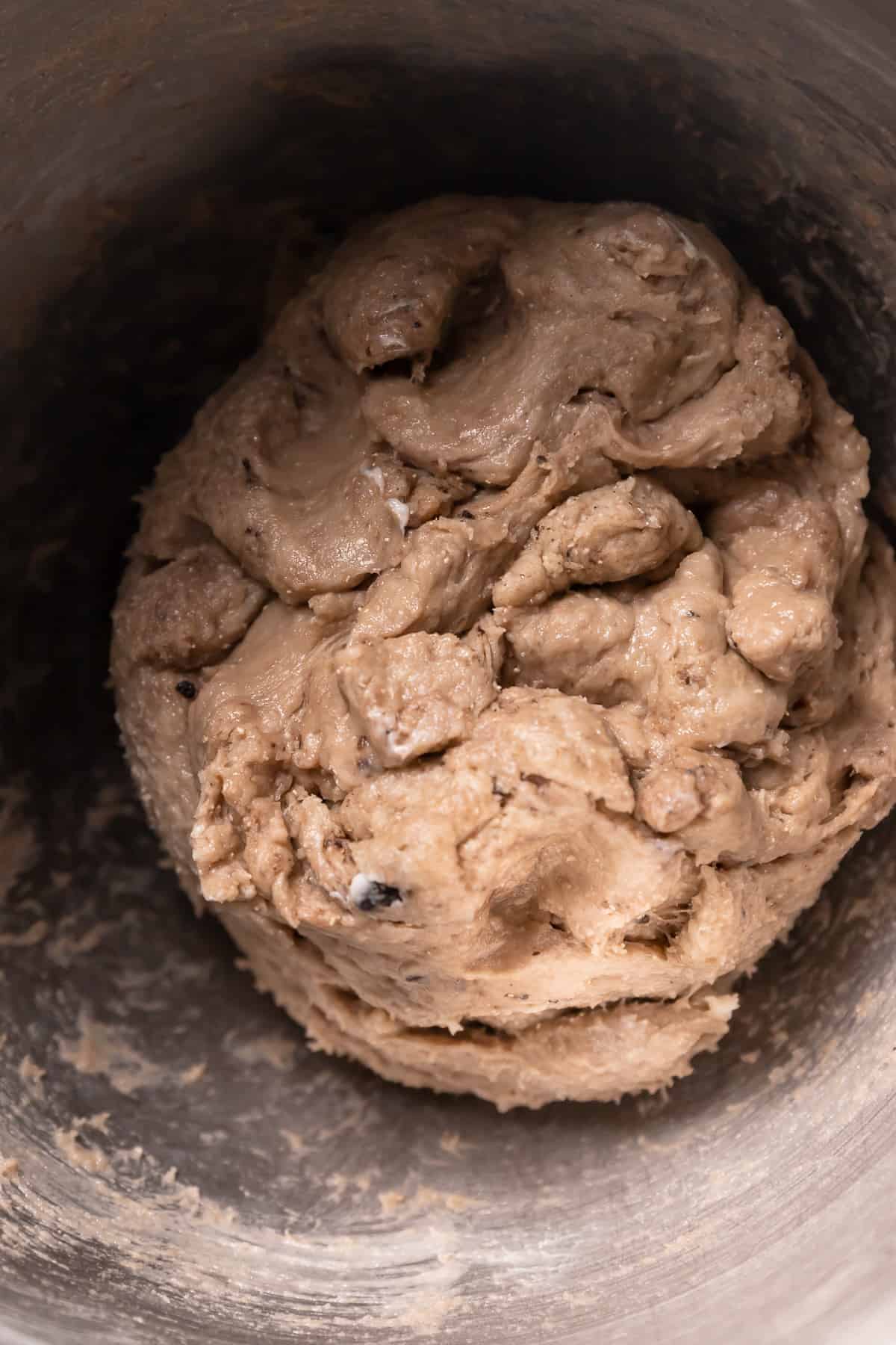 cinnamon roll dough ball in a mixing bowl.