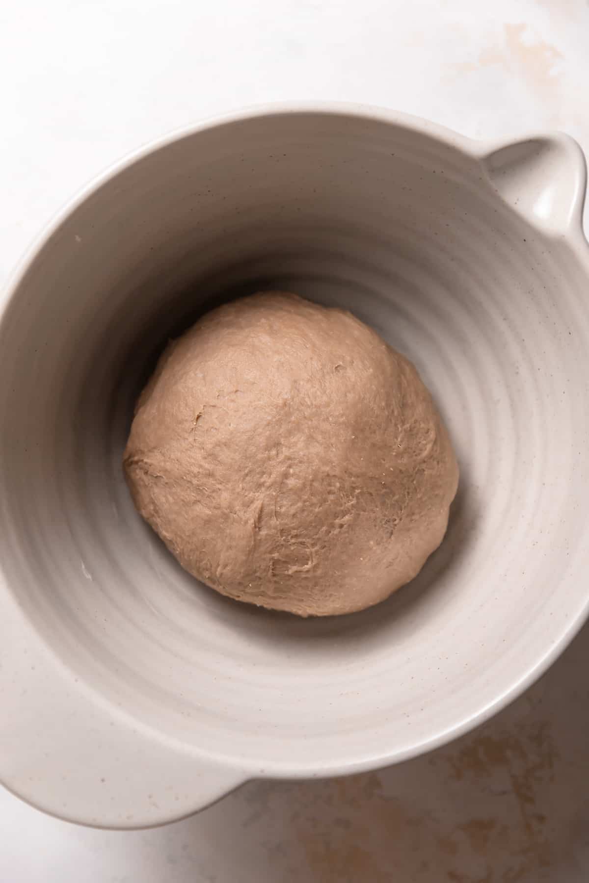round dough ball in a mixing bowl.