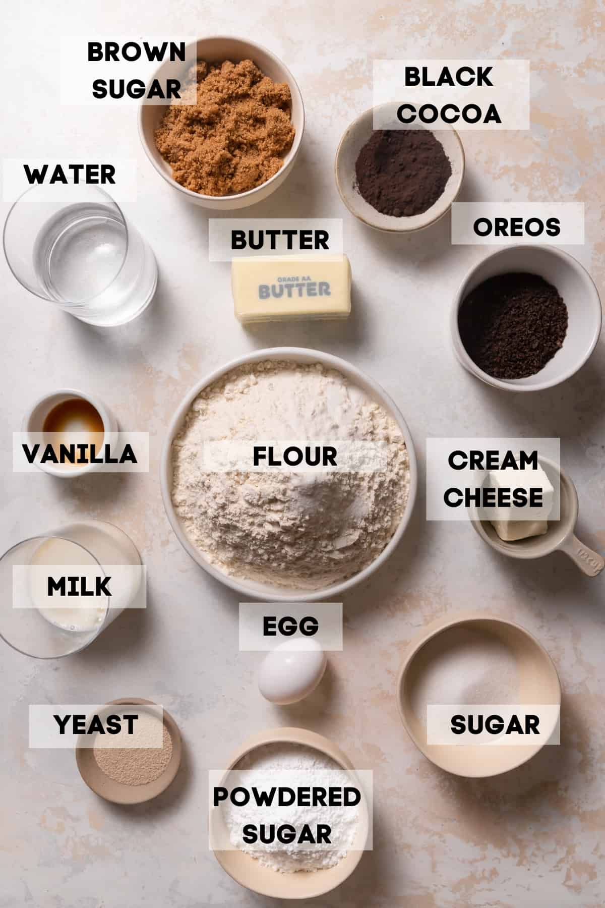ingredients needed to make homemade cinnamon rolls in bowls with labels.