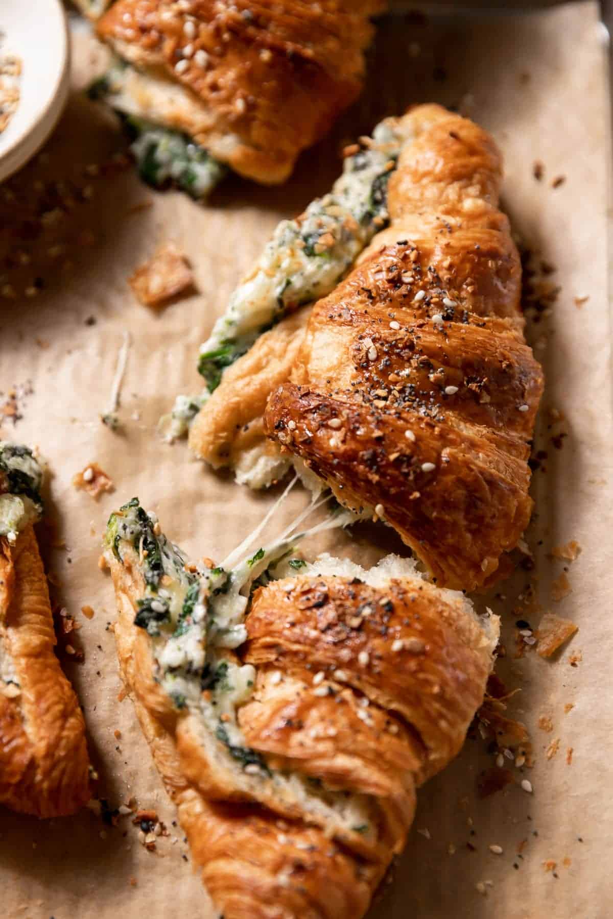 baked croissant with cheese and spinach filling.
