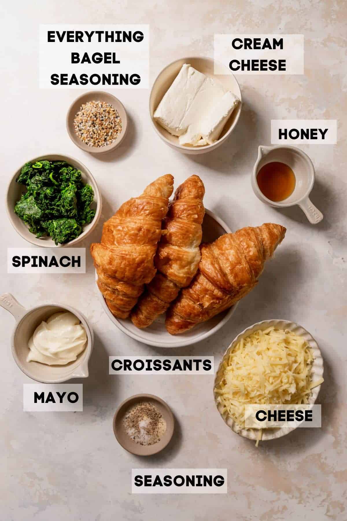 ingredients needed to make spinach croissants in bowls with labels.