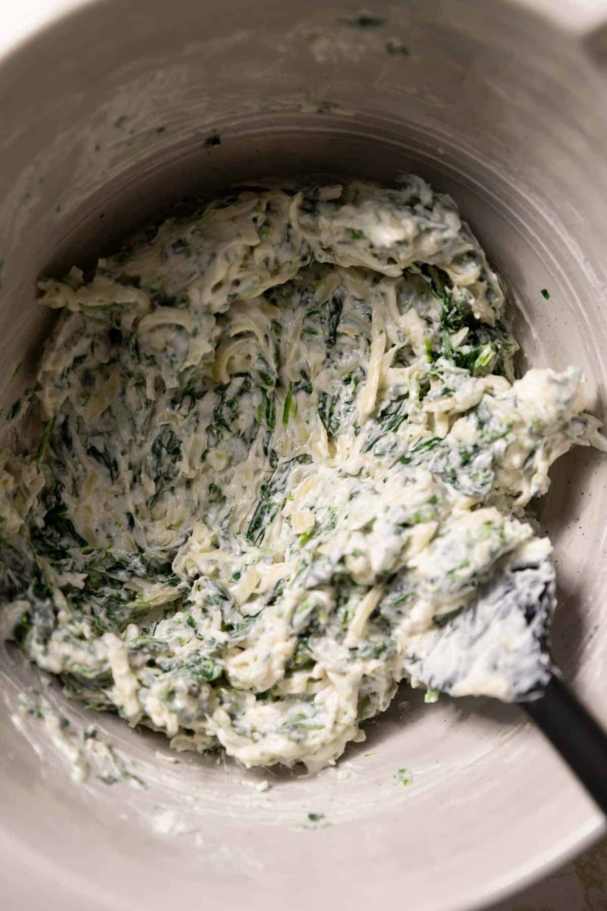 creamy spinach filling in a mixing bowl.