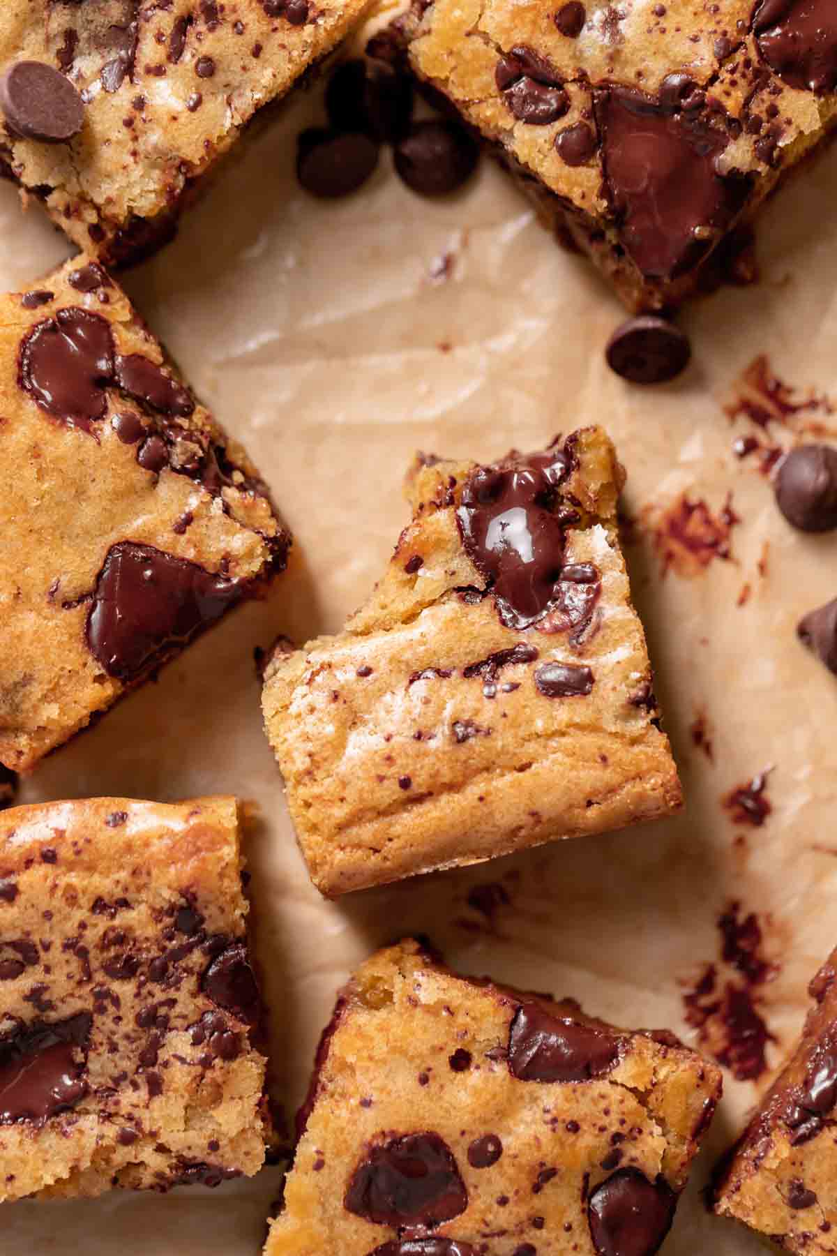 chocolate chip blondies on brown parchment paper.
