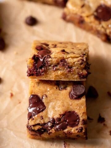 chocolate chip blondies stacked on top of each other.