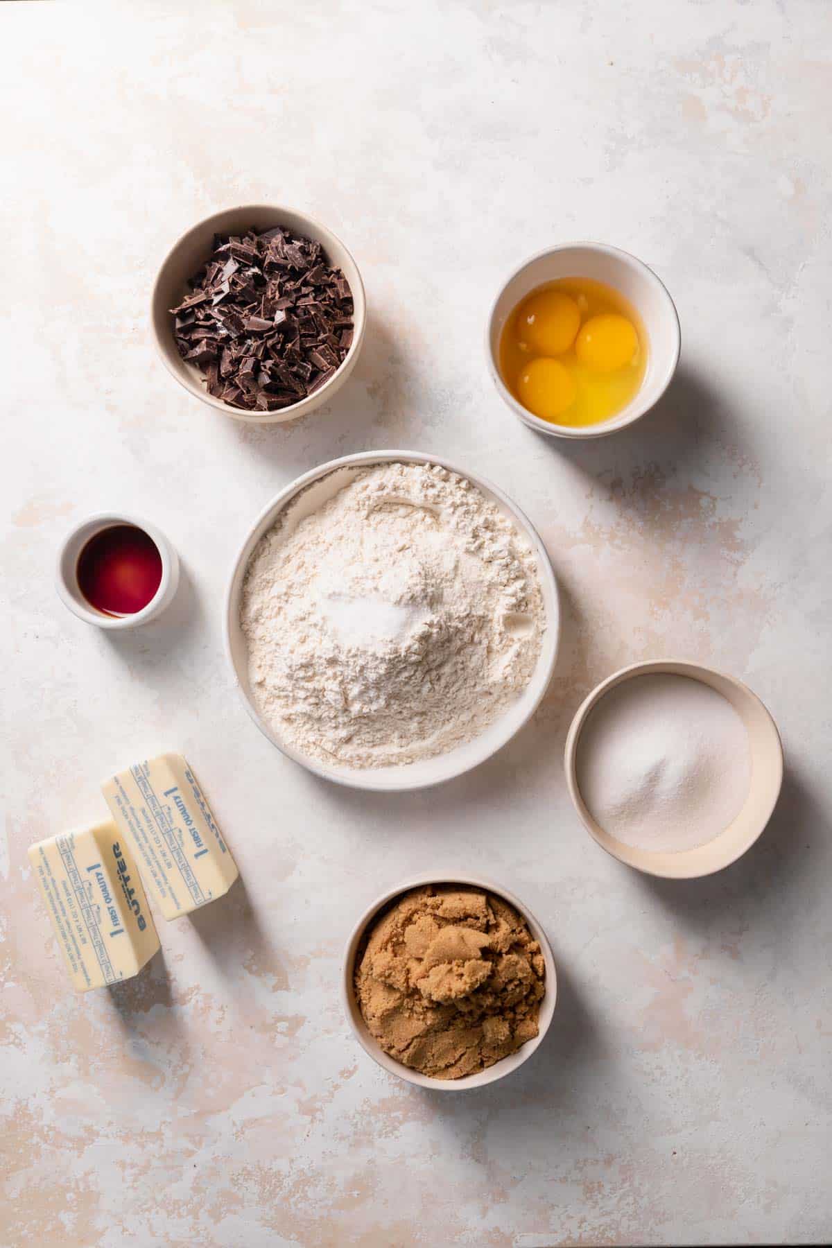 ingredients needed to make chocolate chip blondies in bowls with labels.