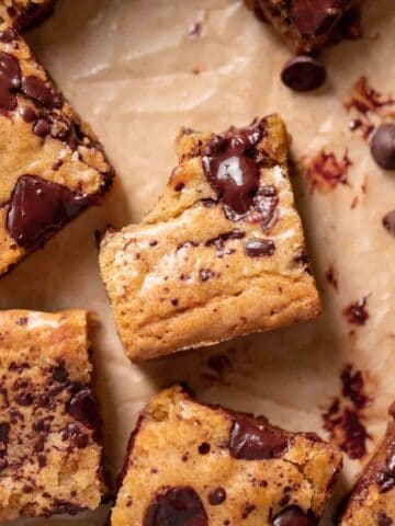 chocolate chip blondies on brown parchment paper.