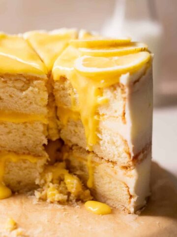 lemon bar cake with lemon curd and fresh lemon slices on top.