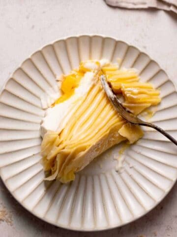 a slice of crepe cake on a white plate.