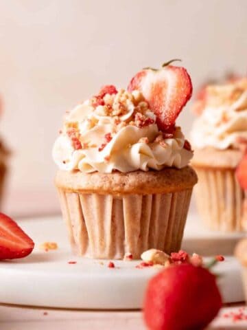 strawberry crunch cupcake with vanilla frosting and crunch topping.