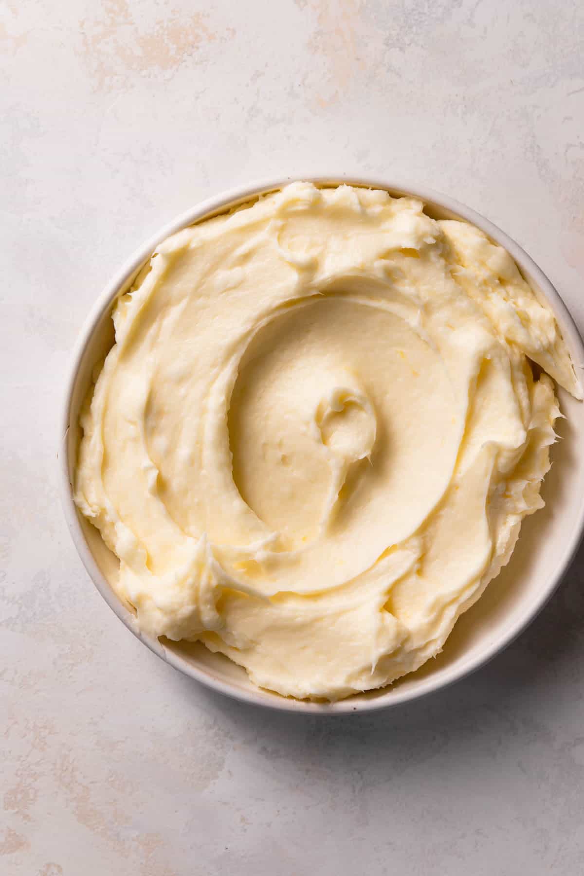 lemon cream cheese frosting in a white bowl.