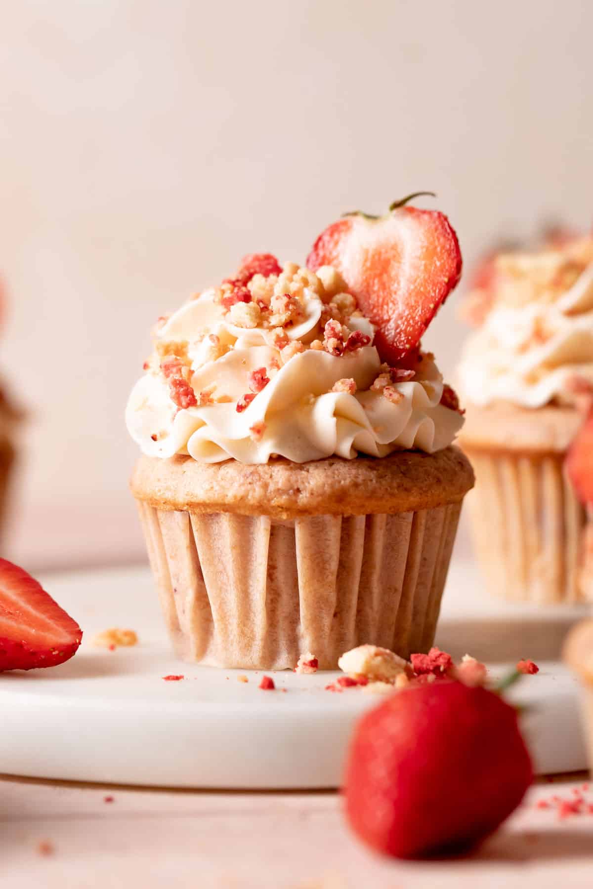 strawberry crunch cupcake with vanilla frosting and crunch topping.