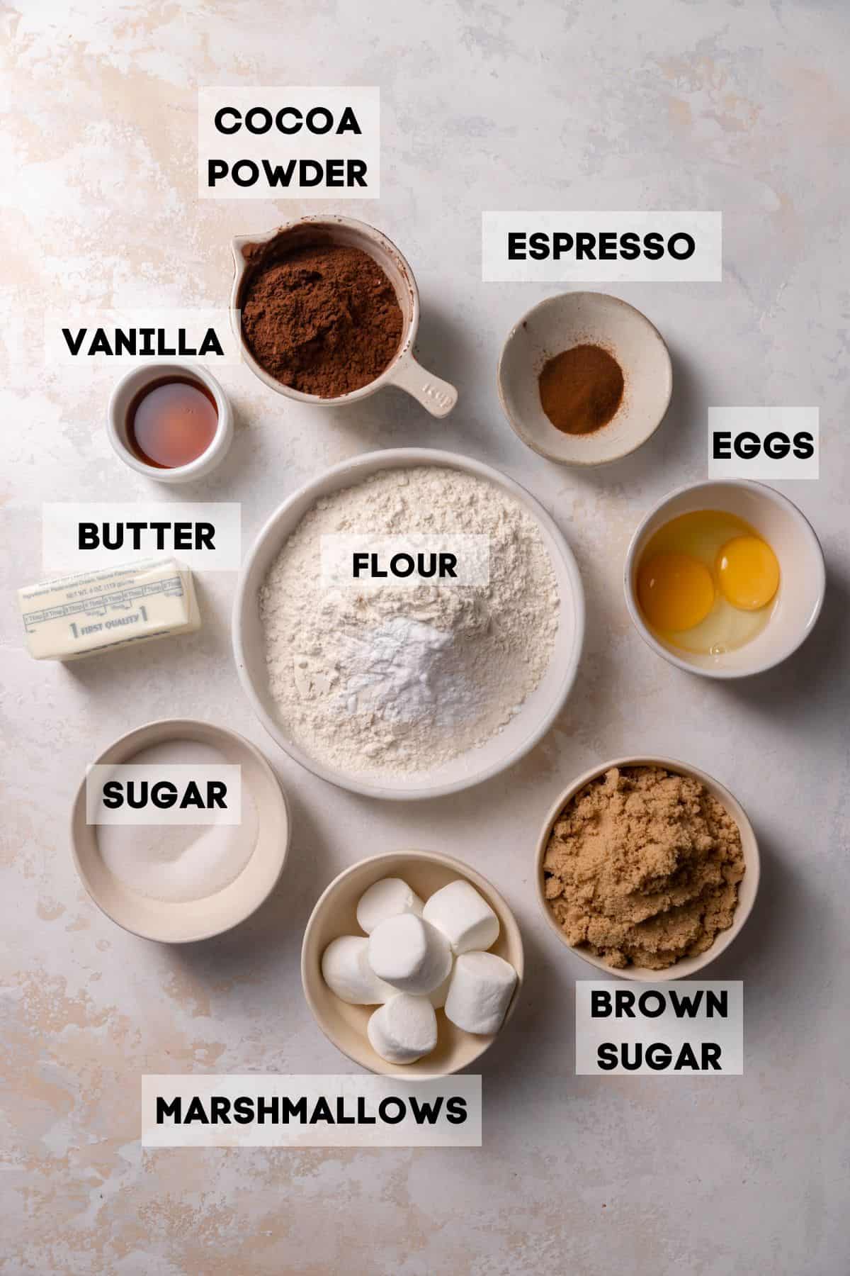 ingredients needed to make marshmallow cookies in bowls with labels.