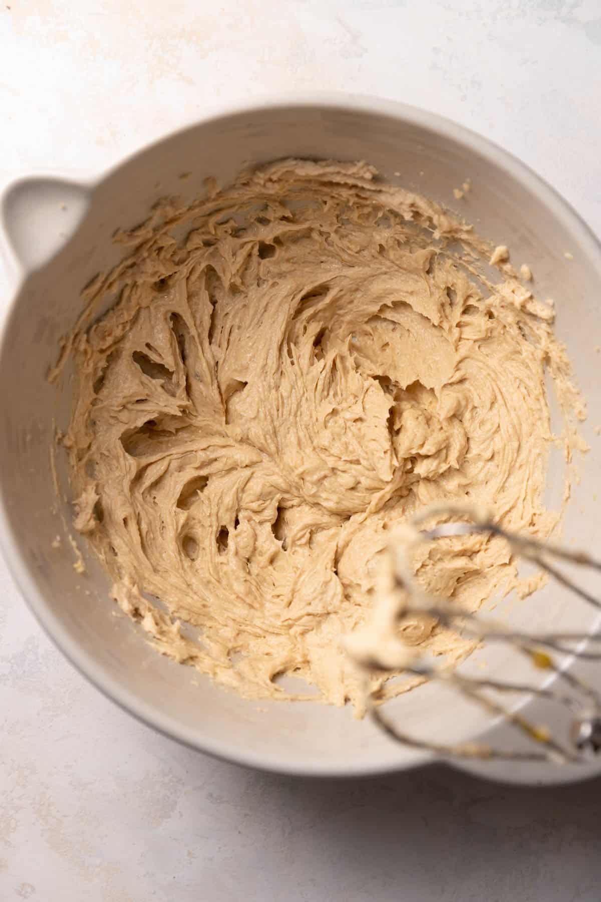 a mixing bowl with wet cookie dough.