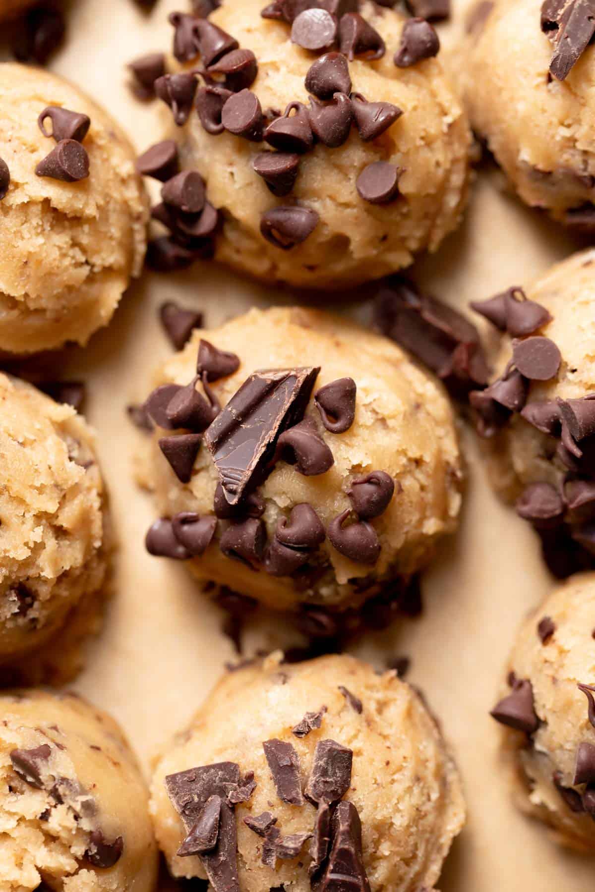 cookie dough balls with chocolate chips on top.
